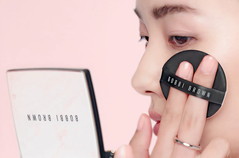 Close up of model eye showcasing defined brows and a natural, shimmery eye look