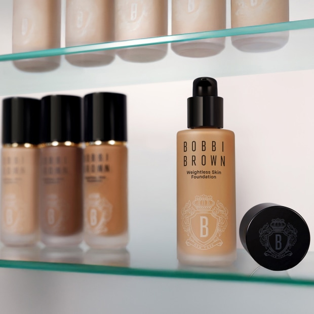 Close up of model eye showcasing defined brows and a natural, shimmery eye look